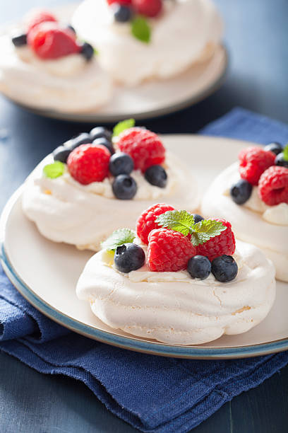 istock pavlova meringue cake with cream and berry 479494036