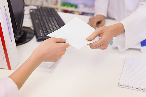 istock Pharmacist giving prescription to costumer 479494066