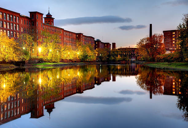 Nashua, New Hampshire Nashua, New Hamshire industrial Mills refection along the banks of the Nashua River on a calm night. Nashua is the second largest city in the state of New Hampshire. Nashua is known for its  livability and economic expansion as part of the Boston region nashua new hampshire stock pictures, royalty-free photos & images
