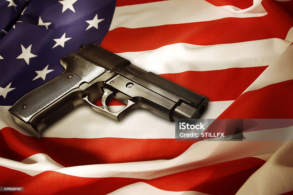 Gun Handgun lying on American flag Gun Stock Photo