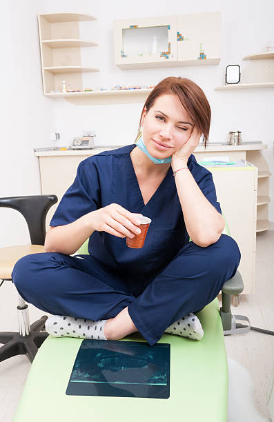 istock Tired female dentist doctor taking a coffee break 479501392