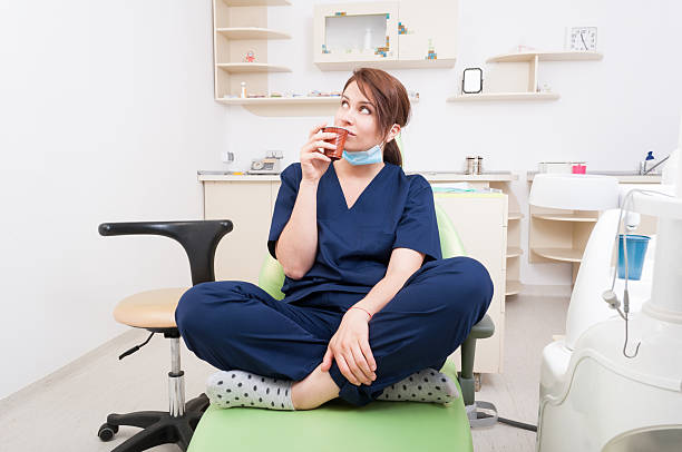 istock Woman dentist doctor thinking and having a coffee break 479501916