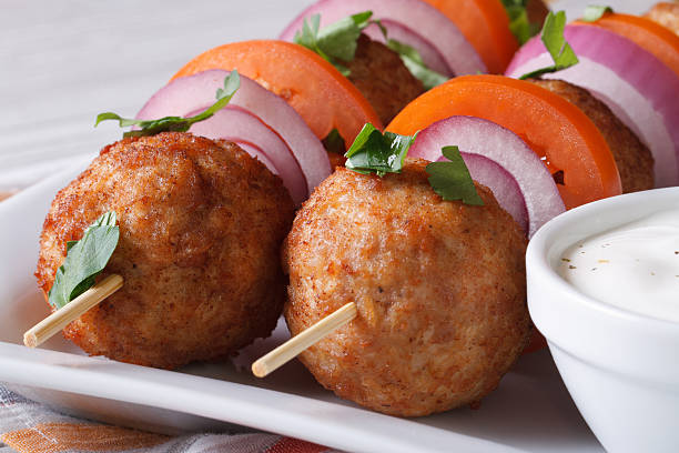 istock meatballs on skewers with sauce on a plate macro, horizontal 479502472