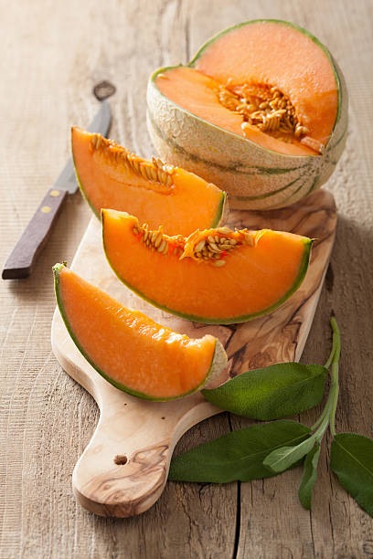 istock cantaloupe melon sliced on wooden background 479502702