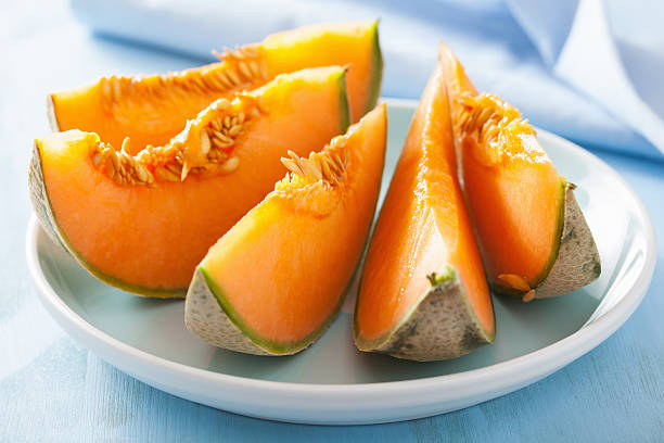 istock cantaloupe melon sliced on blue plate 479502704