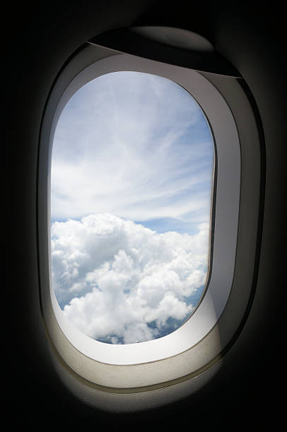 istock Aircraft windows looking out onto the sky and clouds. 479502818