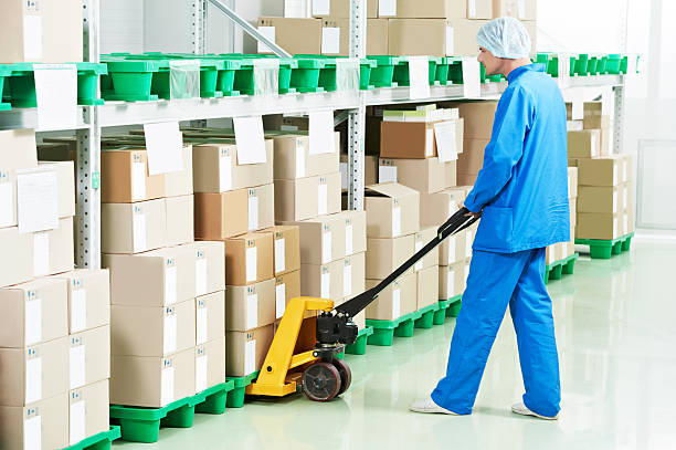 medical warehouse worker medical warehouse worker man loading boxes with medcine drugs by hand forklift  stacker stock pictures, royalty-free photos & images