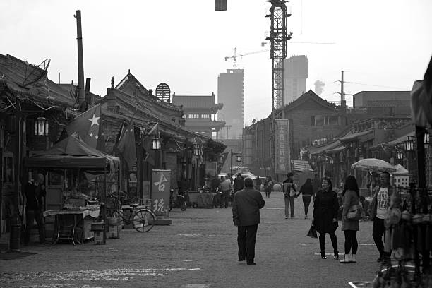 Hohhot, China - October 7, 2014: People walking on an old street with architectural style of the Ming (1368-1644) and Qing (1644-1911) dynasties, in Hohhot, capital of north China's Inner Mongolia Autonomous Region. The street is a popular tourist venue in the city with many souvenir stores. 