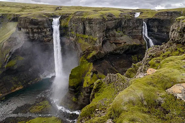 The majestic Haifoss waterfall in Iceland on a cloudy day. The river Fossa, a tributary of Thjorsa, drops here from a height of 122 m. This is the second highest waterfall of Iceland.