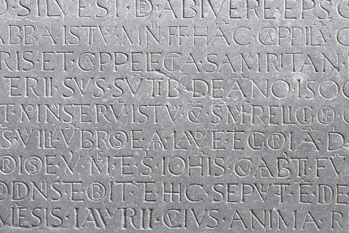 An ancient latin inscription on the marble slab.