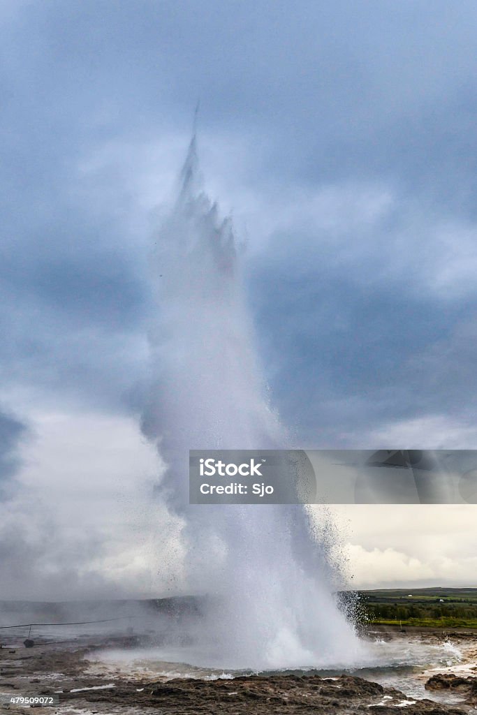 Erupting Strokkuer Geyser in Iceland Eruption of the Strokkur Geyser in the Haukadalur geothermal area in Iceland on a summer's day. 2015 Stock Photo