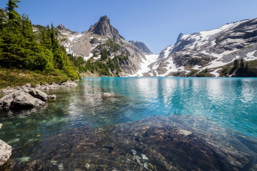 Deep cold water with glacial silt gives Jade Lake its namesake coloring. This remote Alpine Lake is in the North Cascades in Washington State.