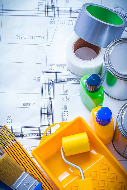 istock Household tape wooden meter and paint tools on construction plan 479511522