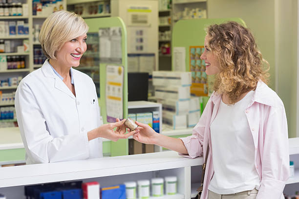 istock Pharmacist and costumer holding medicine jar 479511686