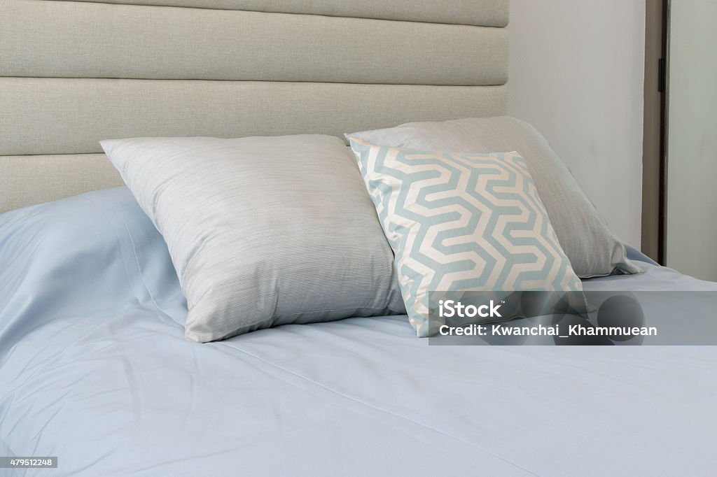 Comfortable soft pillows on the light blue bed 2015 Stock Photo