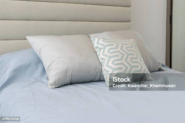 Comfortable Soft Pillows On The Light Blue Bed Stock Photo - Download Image Now - 2015, Apartment, Bed - Furniture