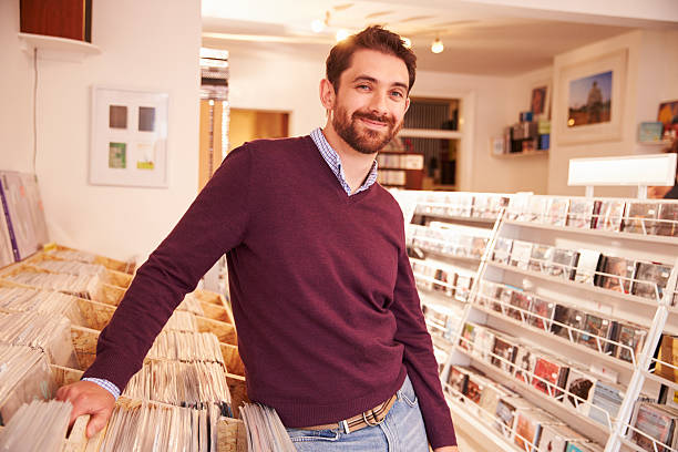 istock Shop owner posing in a record shop, smiling 479513142