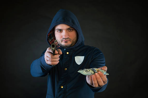 Street thief aimed a gun to tourist victim to attack robbery., Criminal and robbery concept.