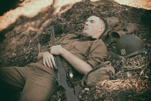 WW2 soldier taking a nap on mulch