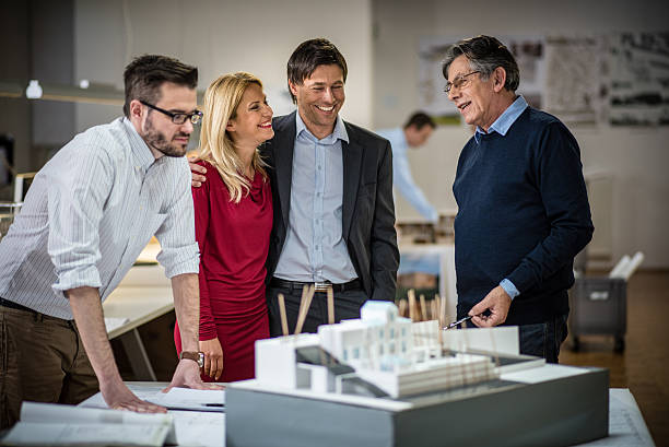 istock Architect with manager explaining project plan to mid adult couple 479514870