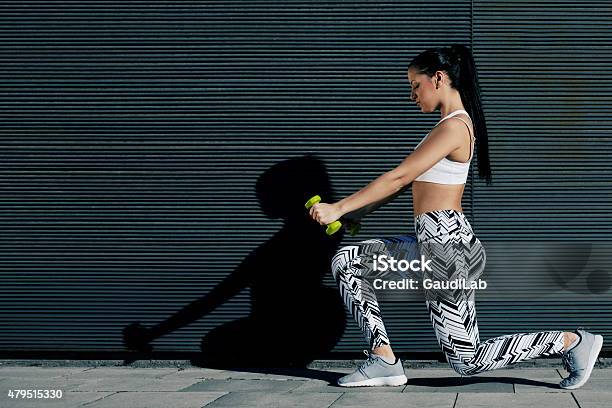 Girl With Strong Body And Perfect Figure Exercising With Dumbbells Stock Photo - Download Image Now