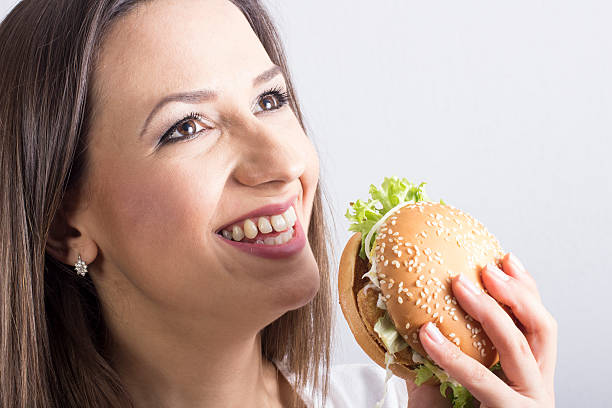 istock woman eating a hamburger 479516295