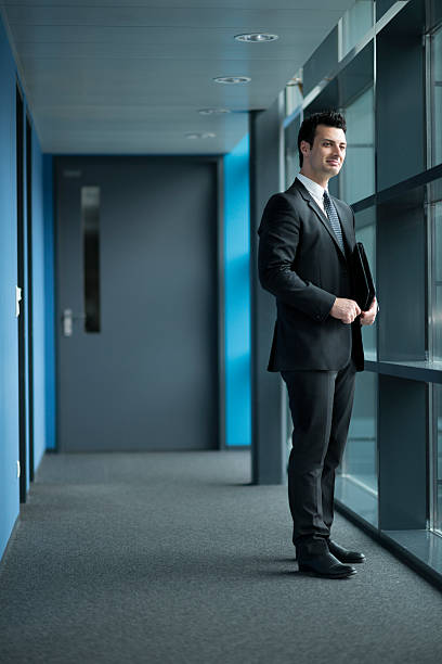 istock happy businessman looking out of window 479519385