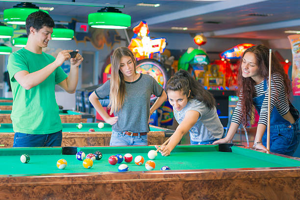 istock Young friends playing pool game or billiard and taking picture 479519412