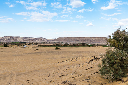 Ancient settlement ruins in Desert Landscape in Middle East. Surreal view of remote location during the day.