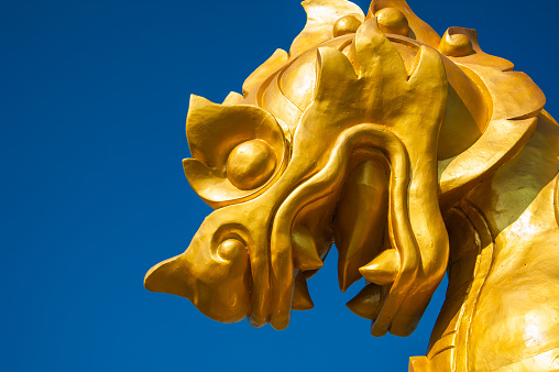 Singha Golden Statue under the blue sky
