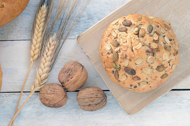 istock traditional bread next to ears (wheat) and some nuts 479521352