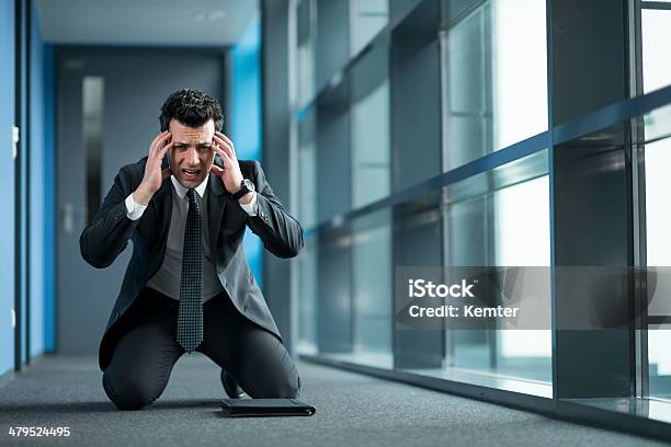 Businessman With Headache Kneeling At Floor Stock Photo - Download Image Now - 30-39 Years, Adult, Adults Only