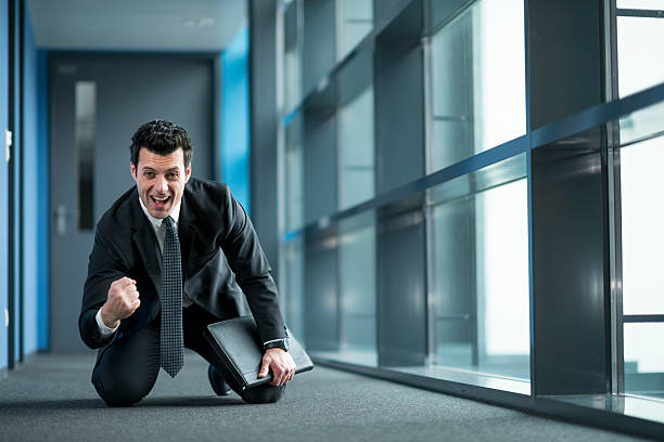 istock happy businessman kneeling at floor 479524519