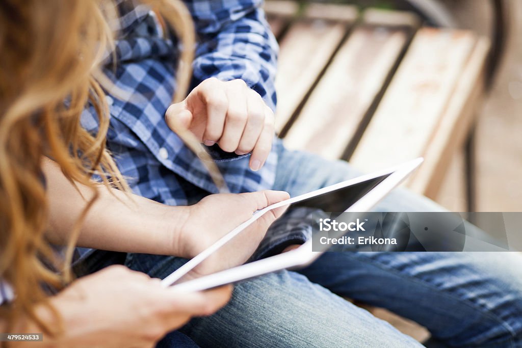 Uses digital tablet Couple uses digital tablet in park Adult Stock Photo