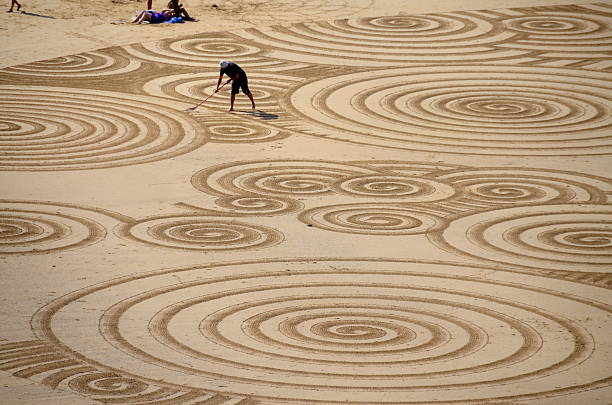 Sand sculpture of a sofa, couch, settee and cushions carved out of golden beach sand