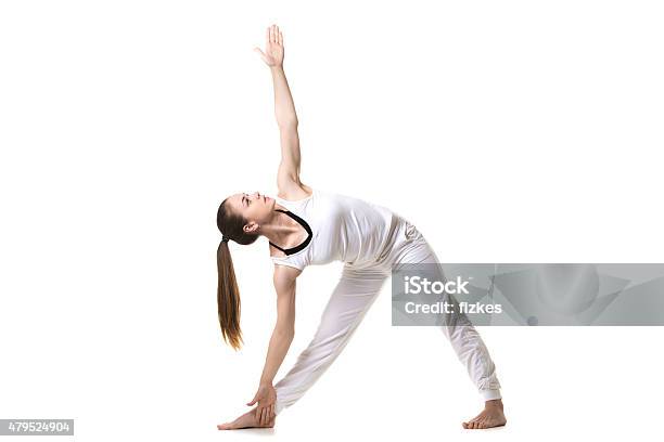 Yoga Trikonasana Pose Stock Photo - Download Image Now - 2015, Activity, Adult