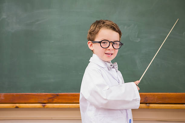 istock Cute pupil holding stick and pointing blackboard 479525802