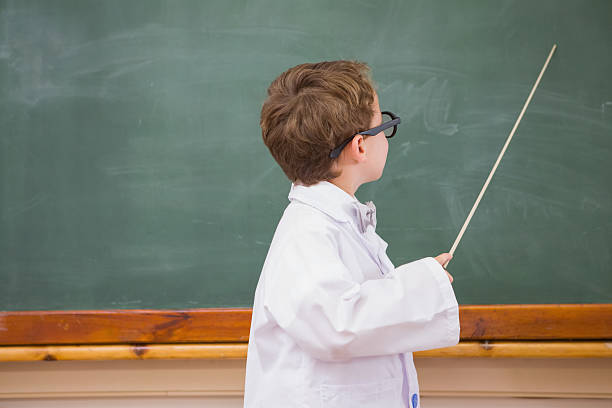 istock Cute pupil holding stick and pointing blackboard 479525814