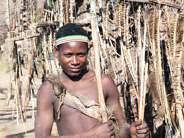 Portrait of Hadzabe (or Hadza) young bushman. The Hadzabe are an indigenous ethnic group in north-central Tanzania, living around Lake Eyasi in the central Rift Valley and in the neighboring Serengeti Plateau. The population of Hadza tribe just under 1000 persons. Endangered tribe. They are among the last hunter-gatherers in the world.