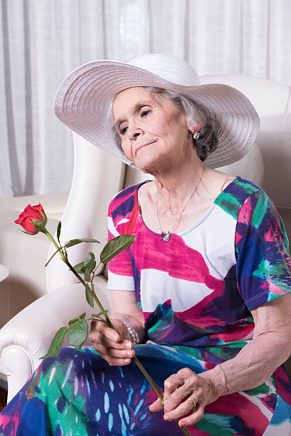 istock active female senior with rose in her hand 479526448