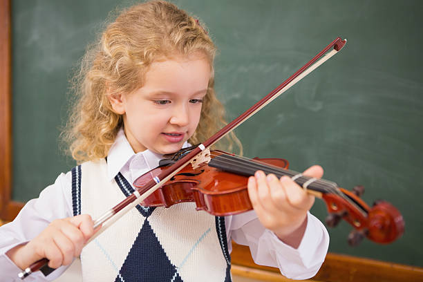 istock Cute pupil playing the violin 479527186