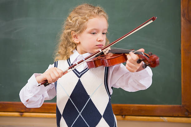 istock Cute pupil playing the violin 479527188