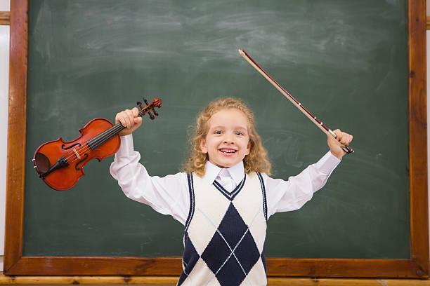 istock Cute pupil holding violin and bow 479527192