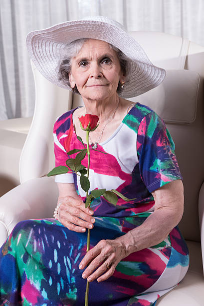 istock active female senior with rose in her hand 479527486