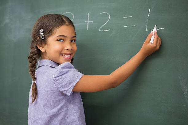 istock Pupil writing numbers on a blackboard 479528240