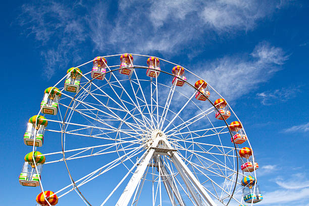Ferris wheel and blue sky in the background stock photo