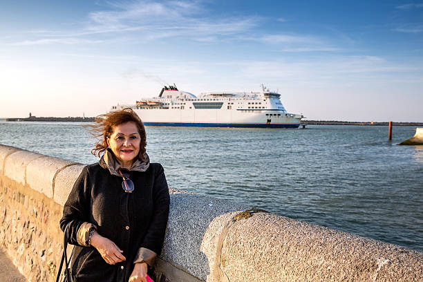 istock Mature smiling hispanic woman standing at harbour 479532462