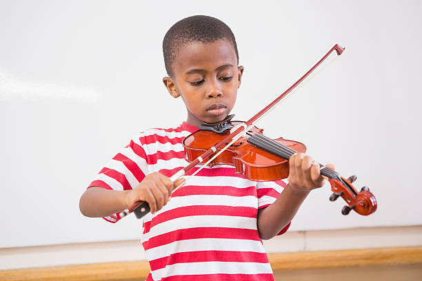 istock Focus pupil playing violin in classroom 479532572