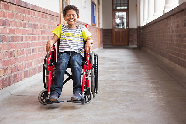 cute disabled pupil smiling at camera in hall - paraplegisk bildbanksfoton och bilder