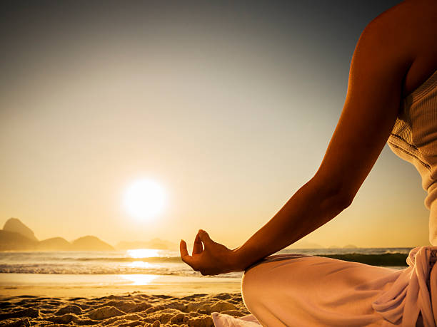 istock Unrecognizable person meditating on the beach at sunset. 479533728